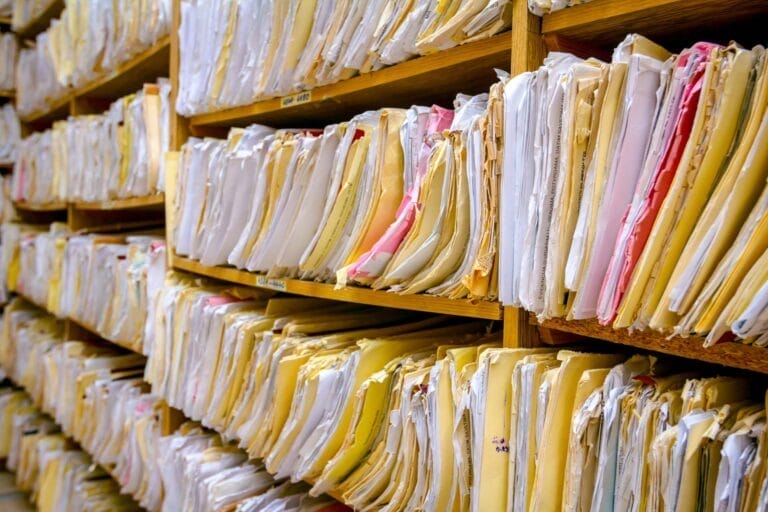 Shelves filled with organized paper files.